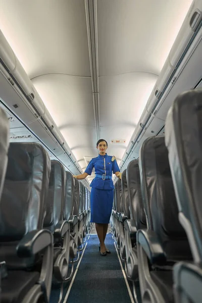 Beautiful young airline hostess at work alone — Stock Photo, Image