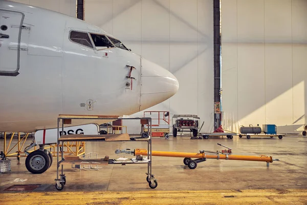 Passenger aircraft in the hangar on the service — Stock Photo, Image