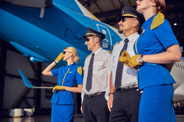 Adult Caucasian pilots and females air hostesses spending time in the outdoors near the aircraft — Stock Photo, Image