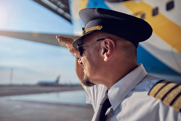 Handsome confident male wearing white shirt and tie standing near the big civil airplane — Stock Photo, Image