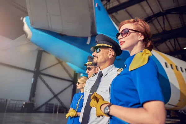Equipe sólida amigável feliz olhando para a distância isolada na grande aeronave de passageiros — Fotografia de Stock