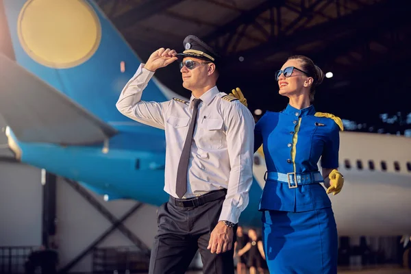 Bonito homem e mulher se divertindo no hangar de aviação — Fotografia de Stock