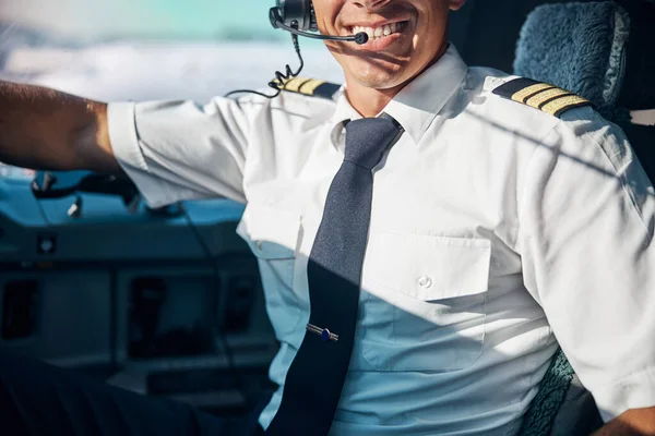 Happy young pilot at workplace in jet — Stock Photo, Image