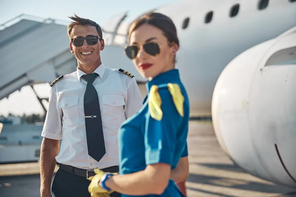 Happy attractive young crew before boarding outdoors — Stock Photo, Image