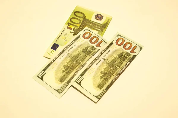 dollars and euro money in a white background