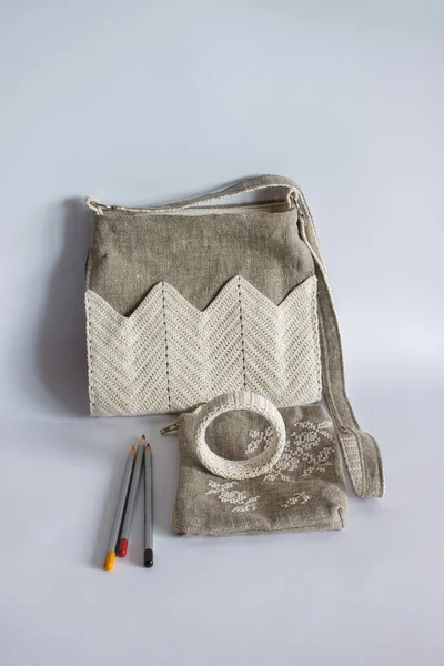 Crossbody bag, makeup bag and bracelet. Linen bag. Knitted white decor. Light background