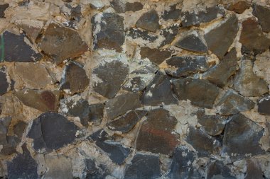 Eski duvar taştan yapılmıştır. Doku ya da arka plan. Parça yakın plan.