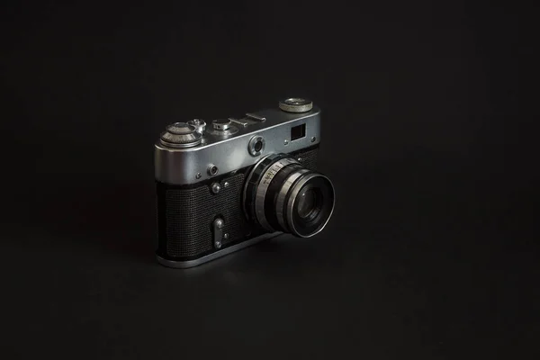 Vintage analog camera on a black background.