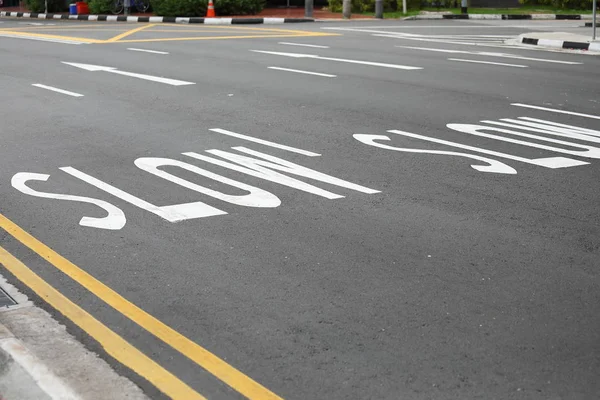 Slow down road sign