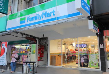 KUALA LUMPUR MALAYSIA - NOVEMBER 22, 2018: Unidentified people visit Familymart convenience store in Kuala Lumpur Malaysia clipart