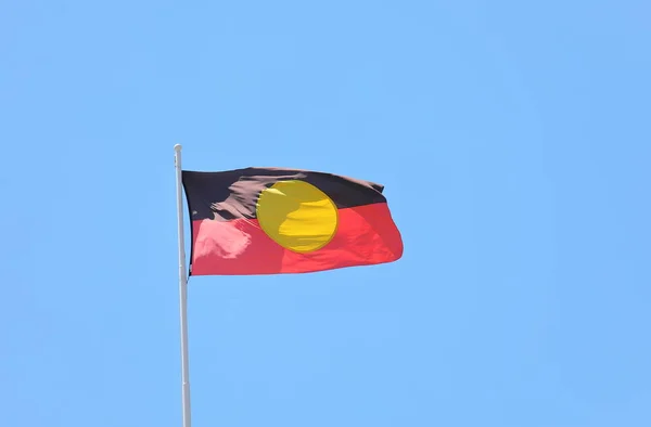 Aboriginal flag in blue sky Australia