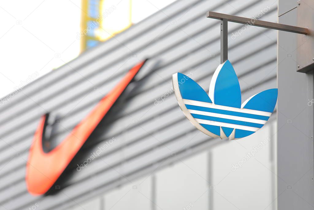 BERLIN GERMANY - JUNE 11, 2019:: Adidas company logo and Nike company logo in background