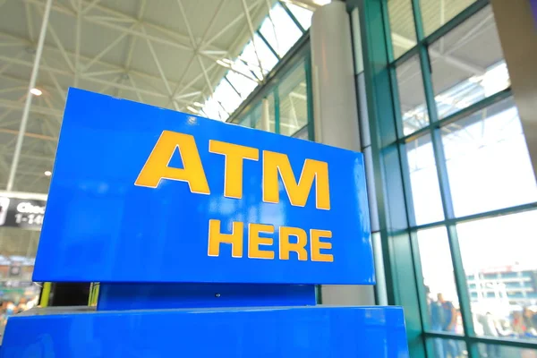 ATM cash machine here sign