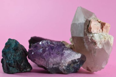 Pembe arka plana yerleştirilmiş mineraller ve kayalar