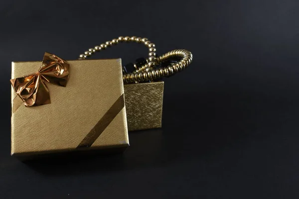 a golden gift on a black background