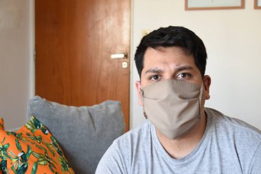 Çene kemeri olan bir adam kameraya bakıyor.