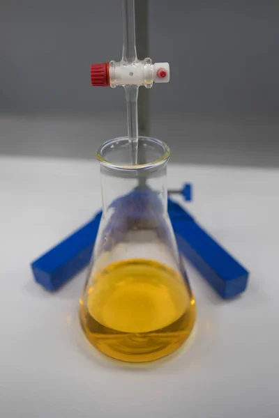 Titration set up in a chemistry laboratory. Orange indicator