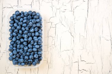 Işık arka plan üzerinde taze yaban mersini. Bilberry ahşap masa üzerinde. Sağlıklı beslenme diyet gıda ve beslenme için kavram. Kopya alanı