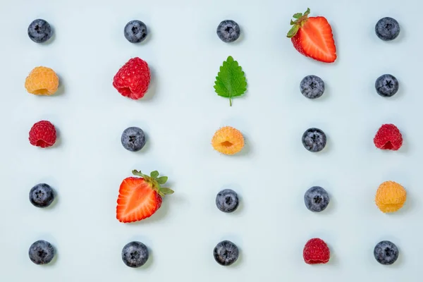 Pattern of berries on blue background. Flat lay mix summer berri — Stock Photo, Image