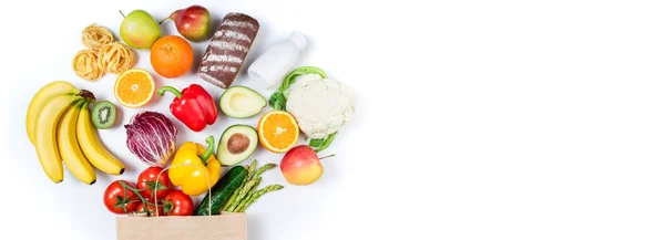 Sağlıklı gıda arka plan. Beyaz arka planda kağıt torba ekmek, süt, sebze ve meyve sağlıklı gıda. Alışveriş gıda süpermarket kavramı. Kopyalama alanı ile uzun biçim