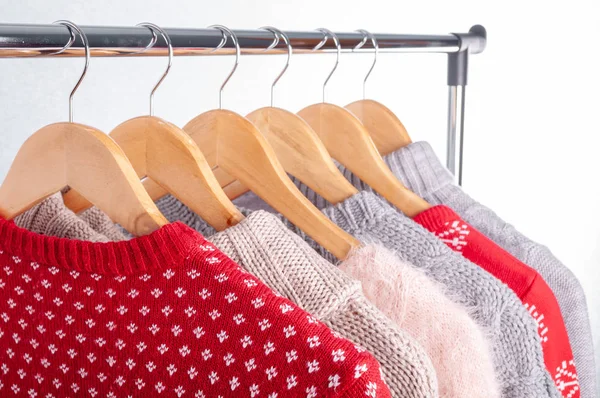 Warm sweaters. Female clothes on open clothes rail. Sale and sho — Stock Photo, Image