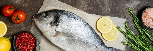 Fresh raw fish closeup. Dorado fish with lemon, spices and herbs — Stock Photo, Image