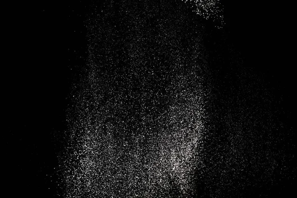 White powder splash isolated on black background. Flour sifting