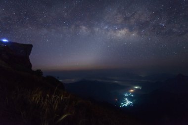 Samanyolu 'nun manzarası, şafak sökmeden önce Chiang Rai, Tayland' da Phu Chi Fa ve Zodiac ışığı üzerindedir..