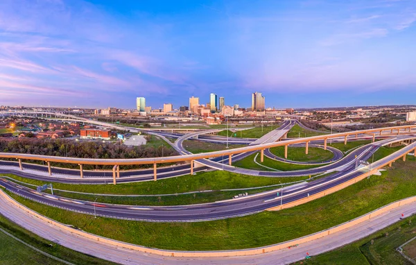 Aerial panorama picture of the Fort Worth skyline at sunrise with highway intersection