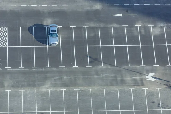 Aerial view of empty car park deck with one lonely car