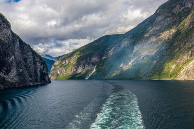 Güneş doğarken Norveç 'teki Geiranger fiyordundan geçerken yolcu gemisinden gelen izlenim