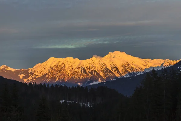 Shot of the pulpit wall in the evening light with the summit illuminated by the evening sun, roaring and fog veils taken in the valley in winter 2013