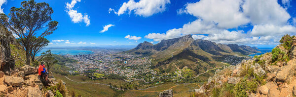 Photograph of Cape Town and Table Mountain from the ascent path to Lions Head during the day in bleuem sky with white clouds photographed in South Africa in September 2013