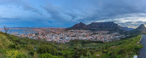 Panoramic photo of Cape Town with Table Mountain from Signal Hill at dusk with illuminated city photographed in South Africa in September 2013