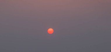 Yazın gün batımında güneşli dramatik ve renkli bir gökyüzü.