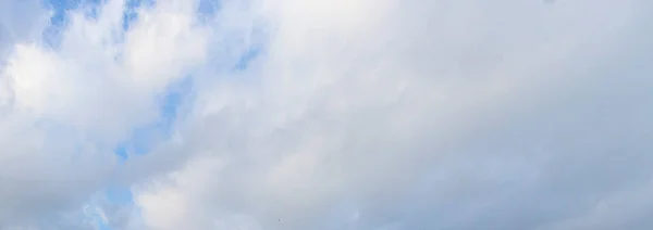 Image of a partly cloudy and partly clear sky during the day without horizon