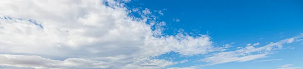 Image of a partly cloudy and partly clear sky during the day without horizon