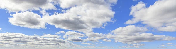 Image of a partly cloudy and partly clear sky during the day without horizon