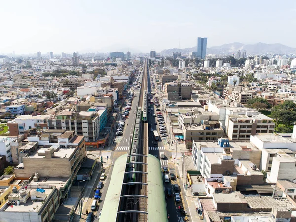 Aerial image of the electric train, train rail and train station in San Borja distrit in Lima Peru.