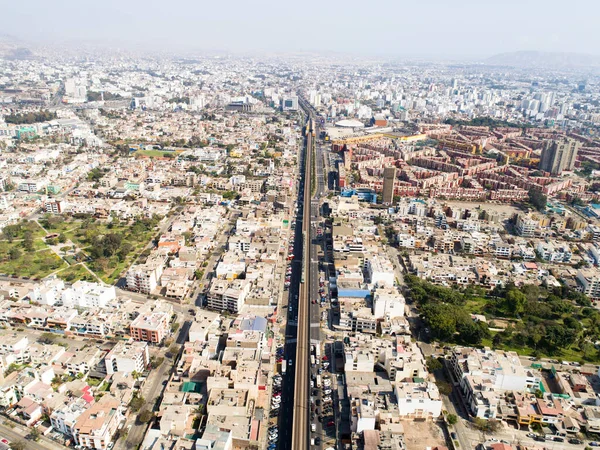 Aerial image of the electric train, train rail and train station in San Borja distrit in Lima Peru.