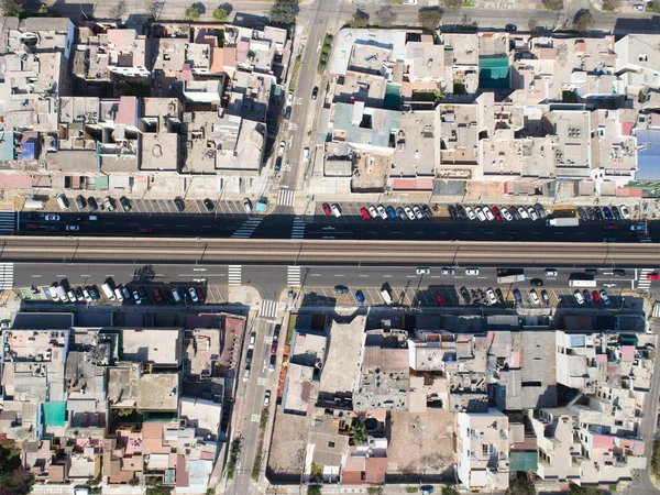 Aerial image of the electric train, train rail and train station in San Borja distrit in Lima Peru.