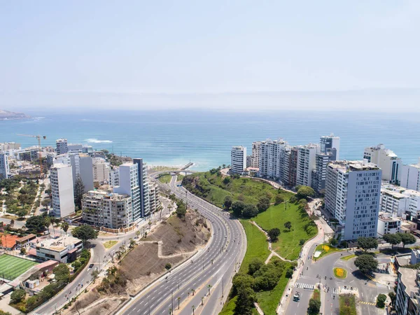 Pazar günleri Lima Peru 'nun insansız hava aracıyla yapılan hava görüntüsü. Sokağa çıkma yasağı nedeniyle özel arabalara izin verilmiyor. İnsanlar plaja doğru bisiklet sürüyorlar. Miraflores Bölgesi.