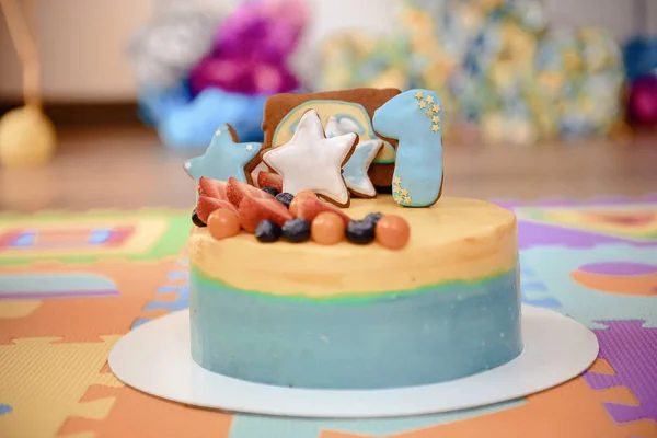 Details of a first year birthday cake in blue, for boy. Colorful decoration of a first year birthday cake
