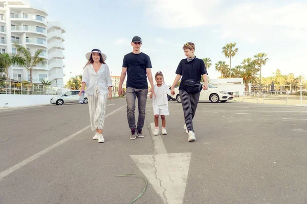 Big happy family with two kids walk in  beach resort having fun.