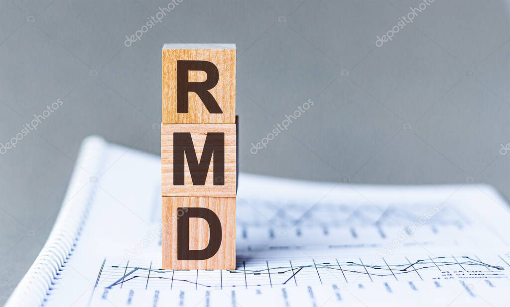 Wooden block with words RMD - acronim RMD - Required Minimum Distributions. Concept image of Accounting Business Acronym RMD Required Minimum Distributions.