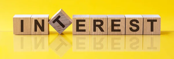 Interest Word Made Building Blocks Concept Yellow Background — Stock Photo, Image