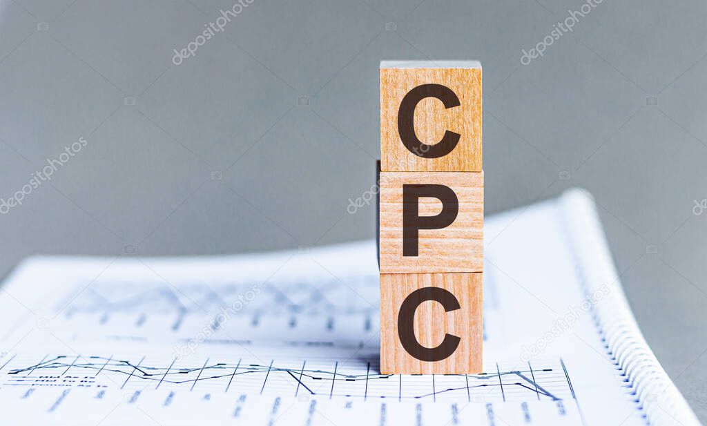 Acronym CPC - Cost per Click. Wooden small cubes with letters isolated on black background with copy space available. Business Concept image.