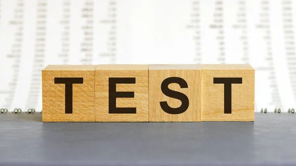 Test word made of wood background. Business concept. Test sign, exam, learning concept. Word test written with wooden cubes. Education quality control. Test background