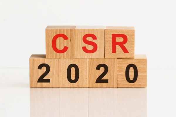 CSR 2020 - customer service representative - acronym from wooden blocks with letters, abbreviation CSR - customer service representative concept, gray background