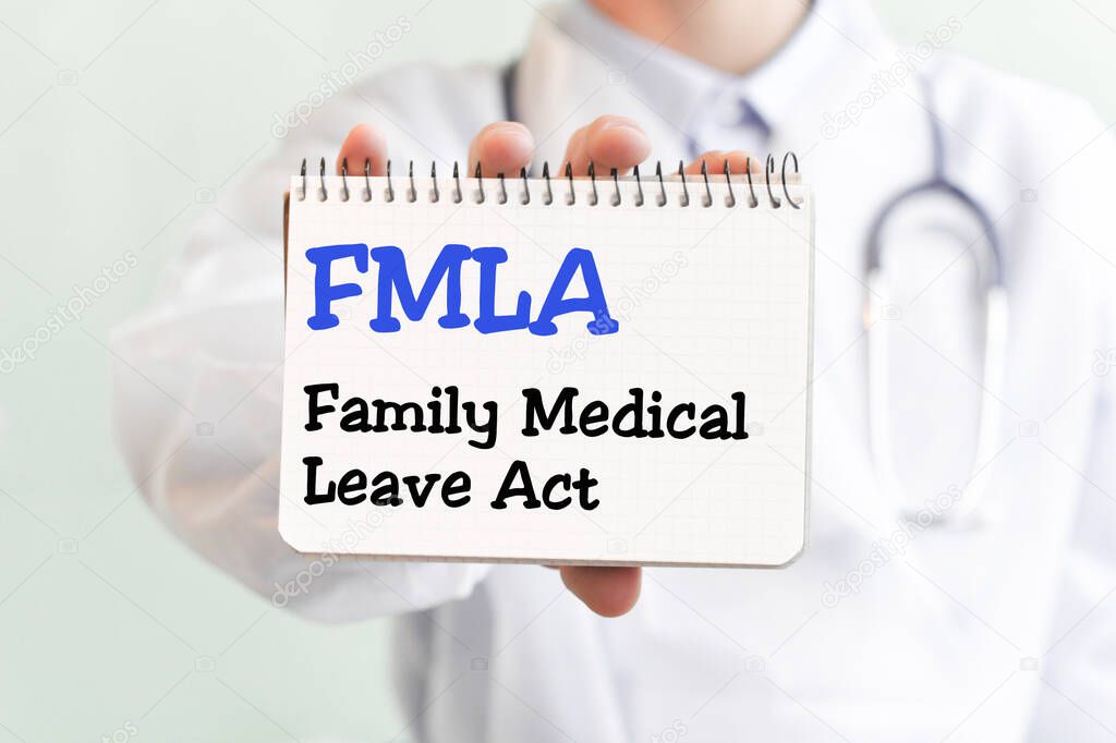 Doctor writing word FMLA Family Medical Leave Act with blu marker, Medical concept